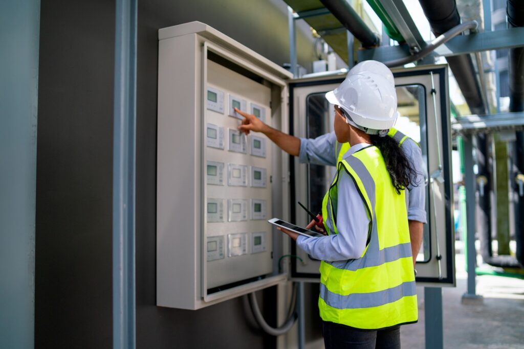 Back of professional engineer or technician workers check and maintenence the monitor
